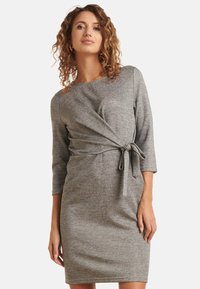 Gray wrap dress with three-quarter sleeves, gathered detailing at the waist, and a tie accent. Made of soft, textured fabric.