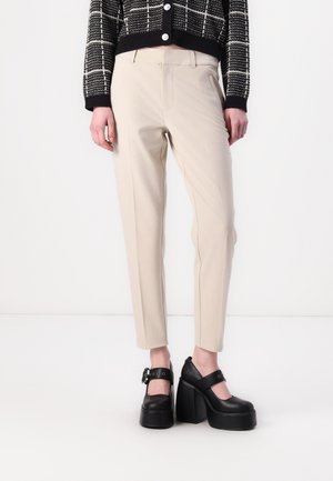 Beige skræddersyede bukser med slim fit, der har flad front, sidelommer og kantdetaljer. Sammen med sorte plateau sko.