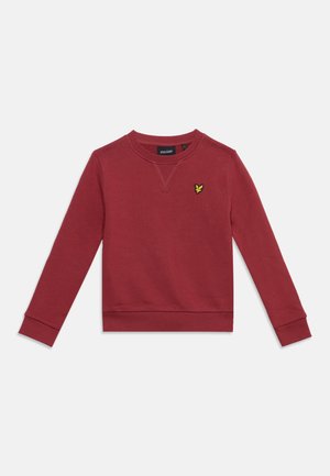 Sweat-shirt manches longues rouge foncé avec col rond et petit logo oiseau jaune et noir sur la poitrine gauche.