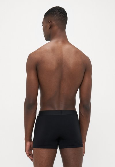 Schwarze Boxer-Briefs aus einem weichen, dehnbaren Stoff. Verfügt über einen glatten Bund und ein figurbetontes Design für optimalen Komfort.