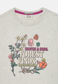 Szara bawełniana koszulka z wielokolorowym graficznym wzorem kwiatów i skał. Zawiera elementy tekstowe "Scotch & Soda" oraz "Forest Finds".