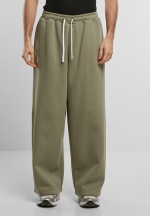 Heleolivrohehised püksid elastse vöökoha, valge nööri ja laiade jalgade disainiga. Valmistatud pehmest, tekstureeritud kangast.