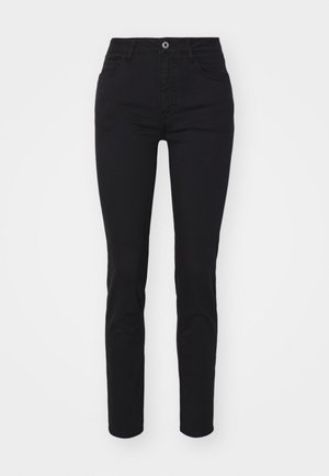 Μαύρες τζιν σκιές σε skinny γραμμή με ψηλή μέση, σχέδιο με πέντε τσέπες, κλείσιμο με ένα μόνο κουμπί και μινιμαλιστικές ραφές.