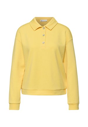 Polo gialla a maniche lunghe con tre bottoni decorativi e polsini a costine, mostrata su sfondo bianco.