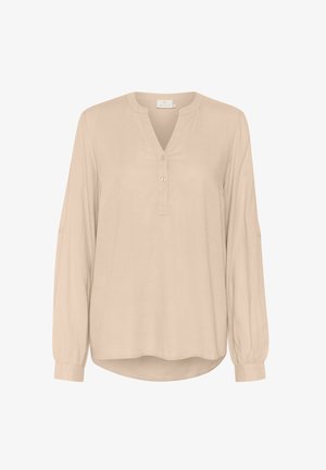 Világos bézs színű, hosszú ujjú blúz V-nyakkal és gombos záróval. Puha anyagból készült, felhajtott mandzsettákkal és ívelt hemmed.