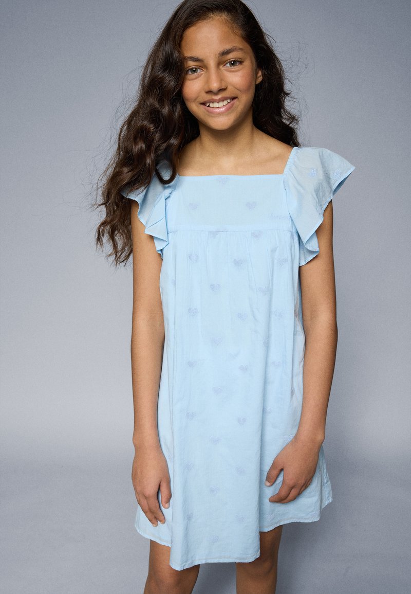 Light blue short dress featuring ruffled sleeves, square neckline, and subtle heart patterns. Made of soft, lightweight fabric.