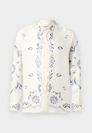 Long-sleeve shirt in cream silk with blue floral patterns, featuring a button-up front and pointed collar, smooth texture throughout.