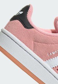 Pink suede sneaker featuring a black leather heel accent, white textured rubber midsole, and a branded side strip with "CAMPUS" in white.