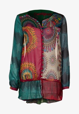 Blouse met lange mouwen en knopen, voorzien van kleurrijke cirkel- en bloemenpatronen op doorschijnende stof in tinten teal, rood, crème en blauw.