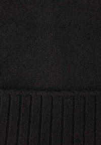 Black knitted beanie with a soft texture. Features a ribbed band at the base. Overall smooth surface, no patterns or embellishments.