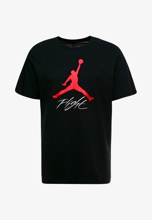Schwarzes Baumwoll-T-Shirt mit einem auffälligen roten Jumpman-Logo und dem Wort "Flight" in weißer Schreibschrift darunter. Kurze Ärmel und Rundhalsausschnitt.