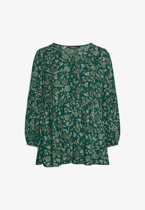 Blouse florale verte avec des manches longues, décolleté en V, détails de bouton et un ourlet à volants. Le tissu présente une finition texturée avec des motifs de fleurs blanches et beiges.