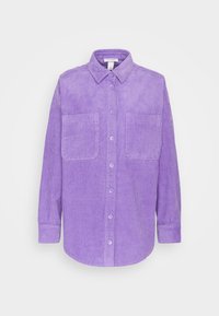 Purple corduroy shirt with a button-up front, two chest pockets, and long sleeves. The texture is ribbed, with a smooth finish.