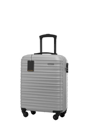 Silver hard-shell suitcase with vertical grooves, black retractable handle, top carrying handle, and four wheels for mobility.