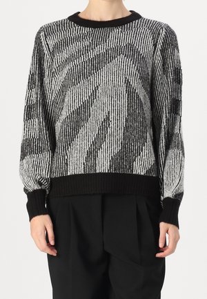 Pull noir et blanc avec un motif rayé, des poignets et un ourlet côtelés, et une coupe décontractée. Fabriqué en matériau tricoté texturé.