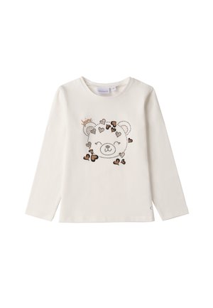 T-shirt a maniche lunghe di colore crema con una grafica di un orso adornata da cuori, contornata da piccole borchie e accentuata da dettagli metallici. Tessuto in cotone morbido.