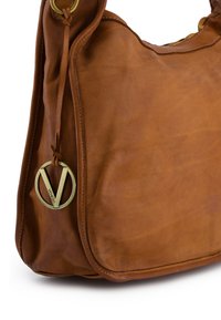 Brun skuldertaske i læder med en glat tekstur og guldfarvet hardware. Har et logoaccenter og et buet design.