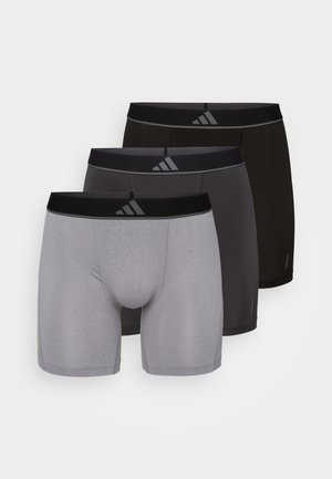 Tres pares de bóxer para hombre en gris, gris oscuro y negro. Cada uno presenta una cinturilla elástica con el logo de Adidas y una textura suave.