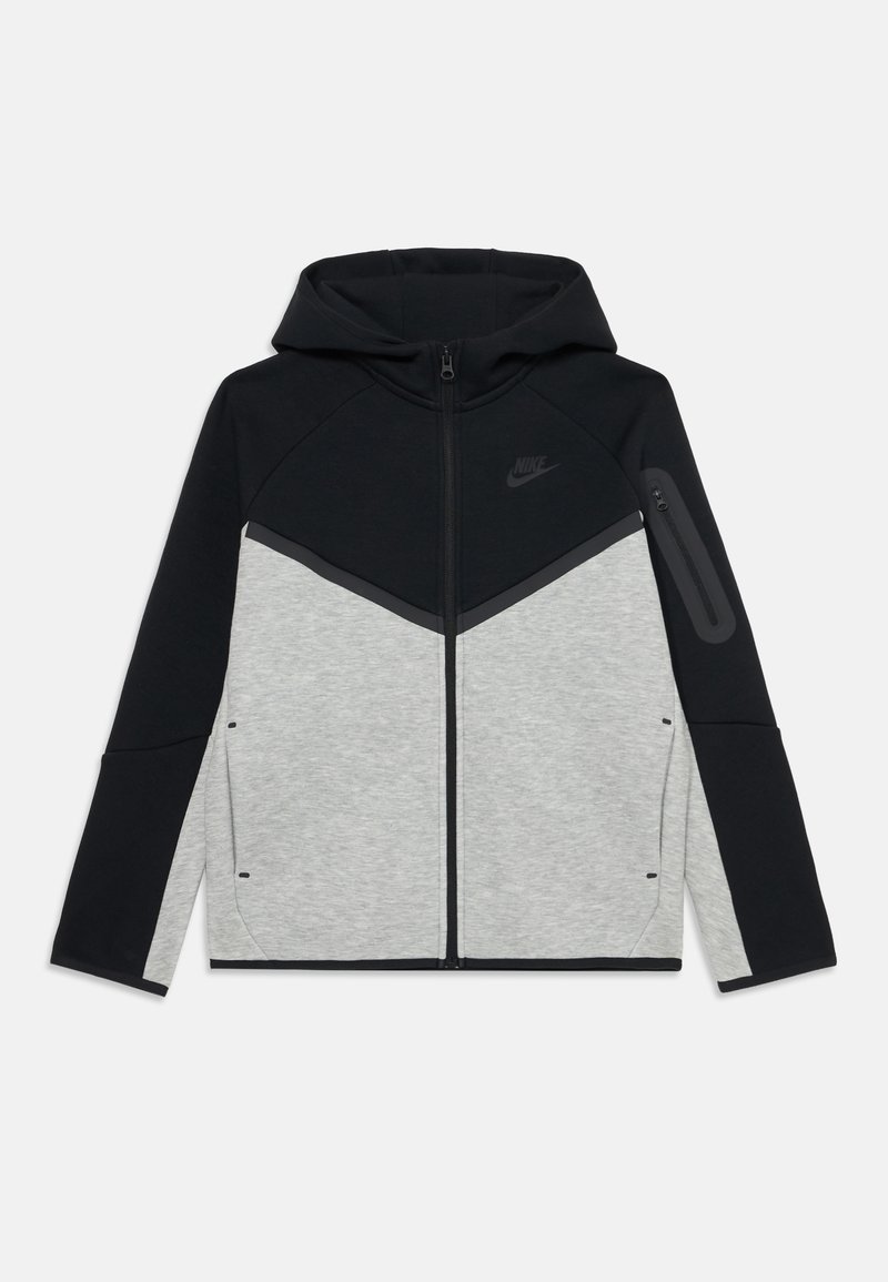 Nike hoodie in black and light gray. Features a zip closure, angled color blocking, and side pockets. Material appears soft and flexible.