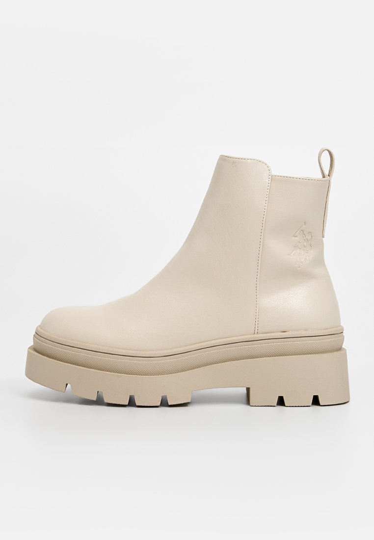 Beige Leder Stiefelette mit einer massiven, strukturierten Sohle und einer glatten Oberseite. Verfügt über eine Schlaufe auf der Rückseite und minimalistische Designelemente.