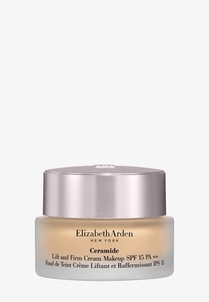 Tarro de maquillaje Elizabeth Arden Ceramide Lift and Firm Cream con SPF 15, tono beige claro, tapa plateada.