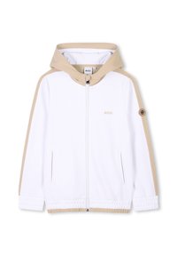 Giacca bianca con zip, cappuccio beige e accenti sulle spalle, dotata di polsini elastici e una texture liscia e morbida. Logo visibile sul petto.