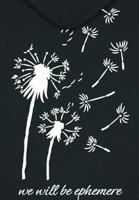 Black hoodie featuring a white dandelion graphic with flowing seeds. Text below reads "we will be ephemere" in a cursive font.
