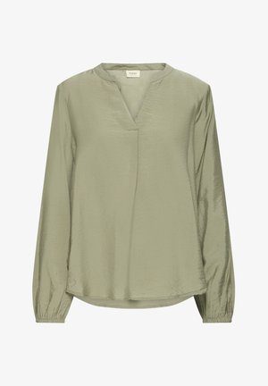 Heledad roheline pikkade varrukatega pluus, millel on V-kaelus ja elastsed mansetid. Disainitud kergelt kõverdatud hemiga ning pehme ja sile kangatekstuur.