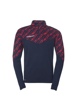 Langærmet atletisk skjorte med høj krave, har en marineblå krop og et markant rødt zigzag-mønster på skuldrene. Branding på brystet.