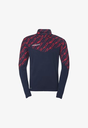 Langærmet atletisk skjorte med høj krave, har en marineblå krop og et markant rødt zigzag-mønster på skuldrene. Branding på brystet.