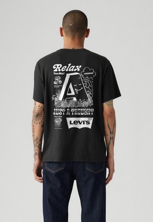Black cotton t-shirt featuring assorted white graphics including "Relax," a large letter "A," and "Levi’s," with a relaxed fit and short sleeves.
