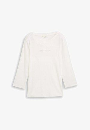 Bijela majica dugih rukava s okruglim izrezom. Ima suptilni detalj s natpisom "TOM TAILOR" sprijeda. Izrađena je od mekog, glatkog materijala.
