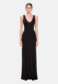 Schwarzes, bodenlanges Kleid aus glattem Stoff; verfügt  über einen tiefen V-Ausschnitt und eine figurbetonte Silhouette. Minimalistisches Design, keine sichtbaren Muster oder Verzierungen.