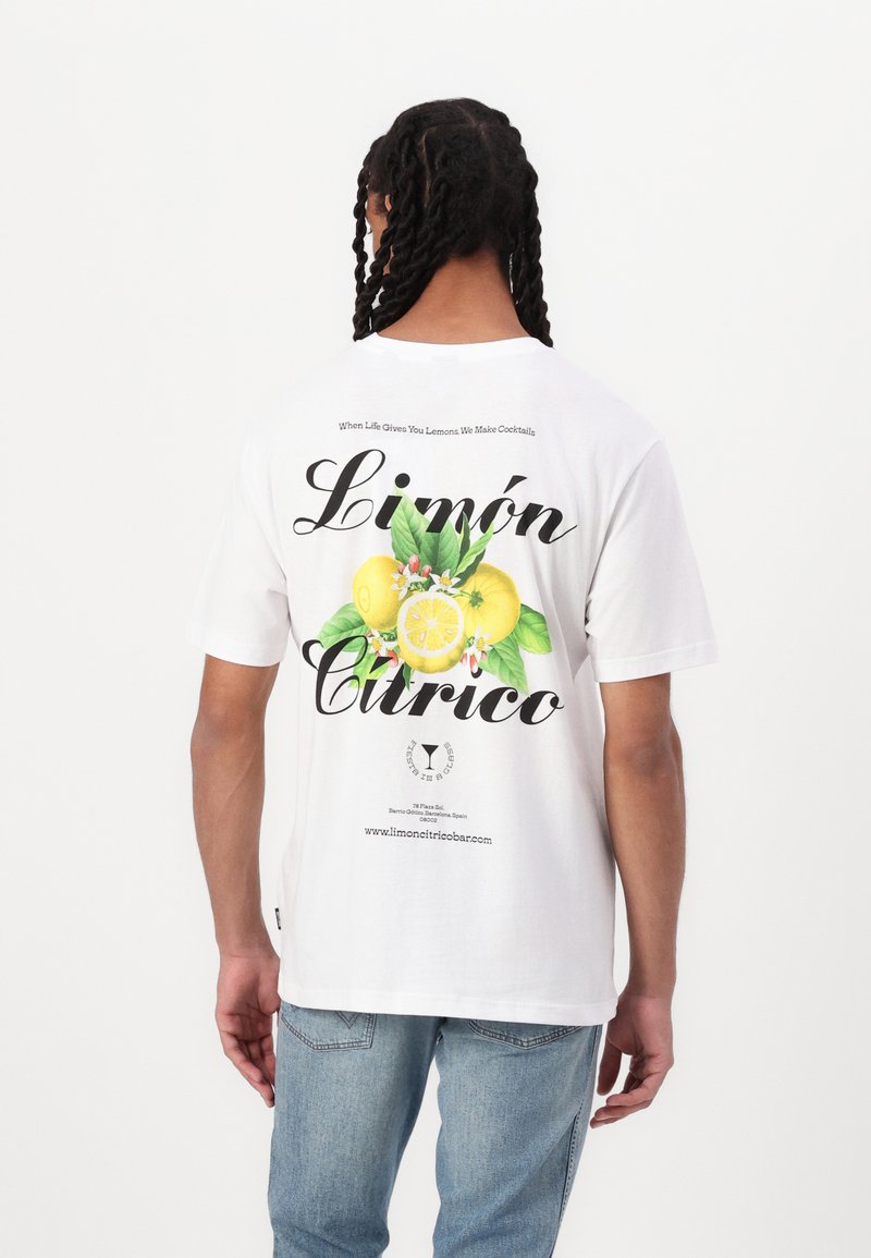 Hvid bomulds t-shirt med et farverigt citron grafik og tekst på ryggen, med en afslappet pasform og korte ærmer.