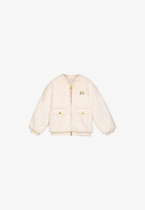 Crèmefarbener Kunstpelz-Jacke mit Reißverschluss, zwei Goldknopf-Taschen und Rundhalsausschnitt. Mit einem bestickten Logo auf der Brust.