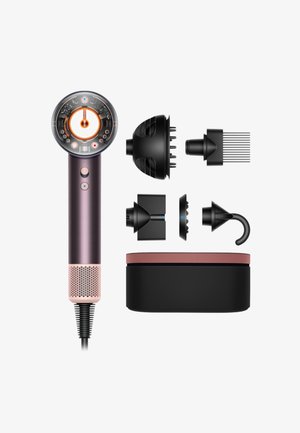 Hairdryer with transparent circular head and five detachable black styling attachments arranged beside a black and pink storage case.