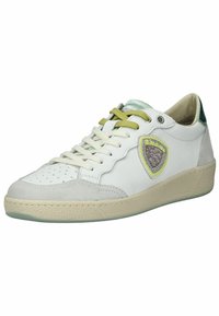 White sneaker with green accents, featuring perforated toe, lace closure, and a textured rubber sole. Includes a decorative logo detail.