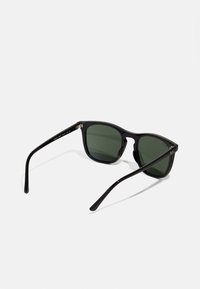Black sunglasses with rectangular frames, green lenses, shiny finish, and slender arms; features logo detail on the side.