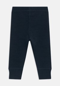 Leggings azul-marinho com um tecido suave e elástico. Apresentam um design ajustado e punhos canelados no tornozelo. Detalhes de costura na parte de trás.