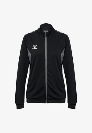 Schwarze Trainingsjacke mit Reißverschluss, hohem Kragen und grauen Akzenten an den Schultern. Sie verfügt über einen strukturierten Stoff und seitliche Taschen. Logo auf der Brust.