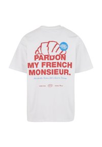 White cotton T-shirt featuring red text "PARDON MY FRENCH MONSIEUR" and a blue round "DAILY BRUNCH CLUB" badge, with croissant graphic above.