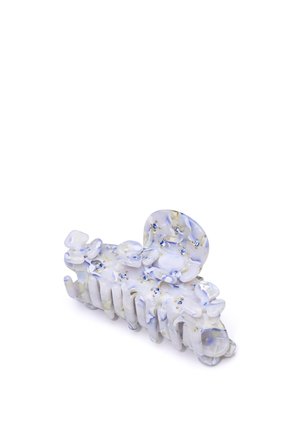 Translucent hair claw in light blue with scattered floral patterns and gold accents, featuring a textured grip and rounded design.