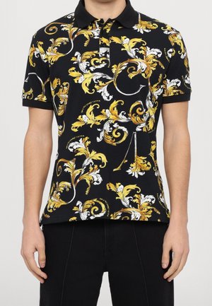 Polo noir avec un motif floral jaune et blanc complexe, manches courtes et col noir contrastant.