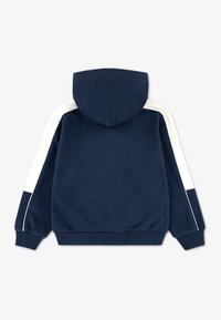 Μπλε ναυτικό φούτερ με κουκούλα και λευκές ρίγες στα πλάγια, με ριγέ μανσέτες και ζωνάκι μέσης. Μαλακό ύφασμα με λεία υφή, casual σχέδιο.