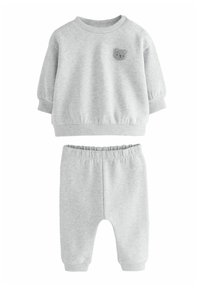 Ljust grå tröja och byxor för småbarn med ribbade muddar och midja, med ett litet lurvigt nallebjörnsansikte på bröstet.