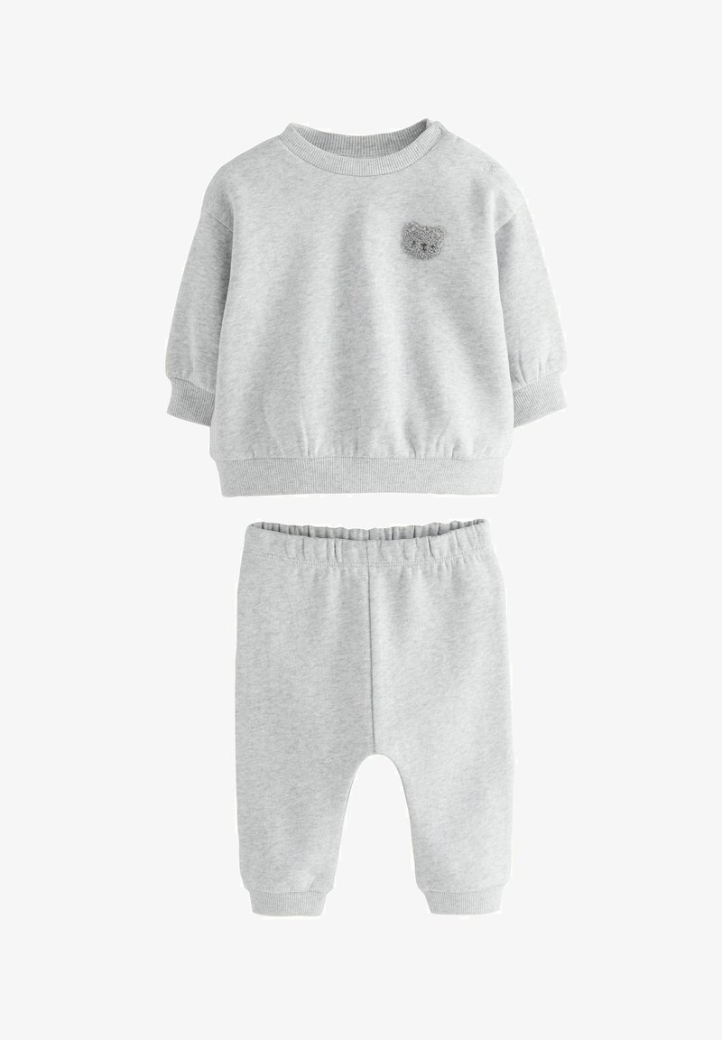 Helles graues Sweatshirt- und Hosen-Set für Kleinkinder mit gerippten Bündchen und Taillenbund, das ein kleines kuscheliges Teddy-Gesicht auf der Brust zeigt.