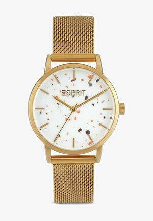 Gouden horloge met een wit gespikkelde wijzerplaat, mesh band, minimalistische uurmarkeringen en een merksymbool op de 12-uurstand.