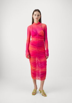 Fitted midi dress with long sleeves, ruched design, gradient pink to orange hue, sheer fabric, and a subtle hardware accent at the neckline.