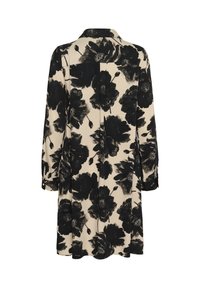 Abito a maniche lunghe in beige chiaro con motivo floreale nero, dotato di colletto, polsini con bottoni e una piega sul retro per un maggiore movimento.