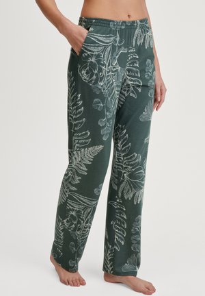 Grüne Hose mit elastischem Bund, die ein weißes botanisches Muster mit Blättern und Blumen aufweist. Hergestellt aus weicher Materialqualität und ausgestattet mit seitlichen Taschen.
